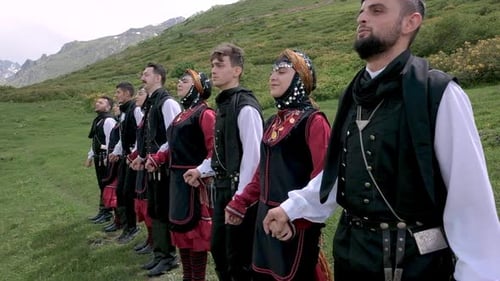 People Wearing Traditional Clothing Holding Hands