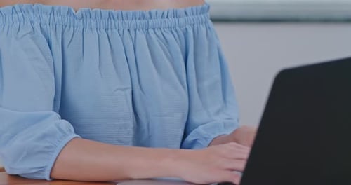 Woman Typing on Laptop Computer at Home