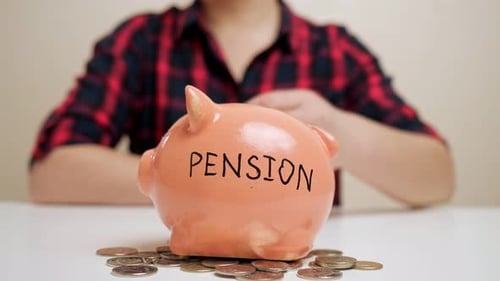 Lady Throws Coin Into Piggy Bank with Pension Inscription