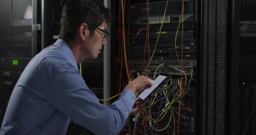 Engineer Using Tablet in Server Room
