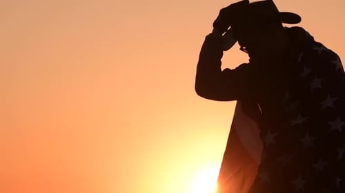 Patriotic Man with a Flag at Sunset