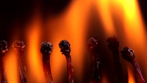 Matches Igniting Chain Reaction on Black Background
