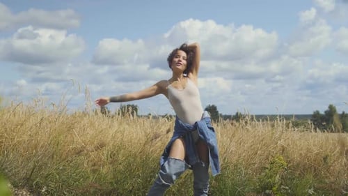 Cute Woman with Short Hair Wearing Bodysuit Relaxing on the Wheat Field