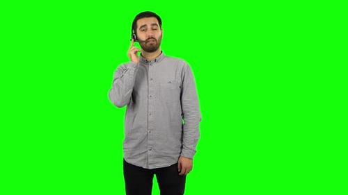 Brunette Guy Is Talking on Headphones, Call Center. Green Screen