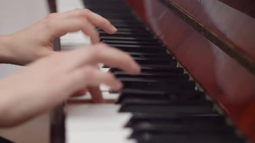 Close-Up of Hands Playing a Piano