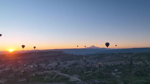 4K Aerial view of Goreme. Colorful hot air balloons fly over the valleys.