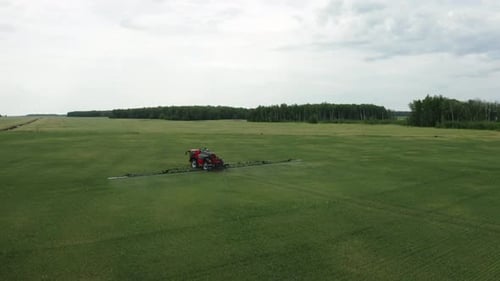 Sprayer Driving Through Green Agriculture Field