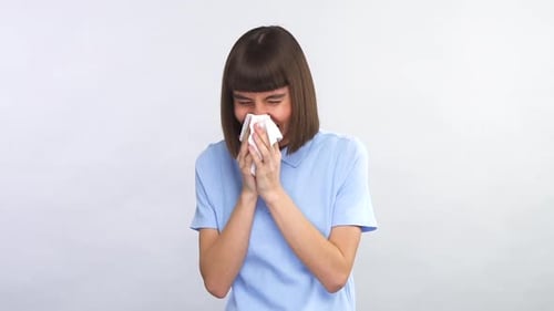 Woman Sneeze In A Tissue