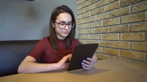 Young Woman Using Tablet in Urban Setting
