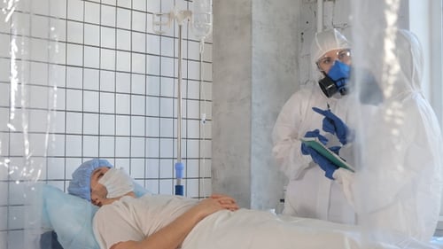 Doctors Examine Patient in Hospital During Pandemic