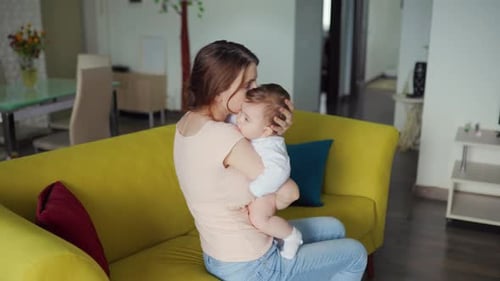Young Mother and Her Baby Woman Hugs Her Child or Adorable Little Girl