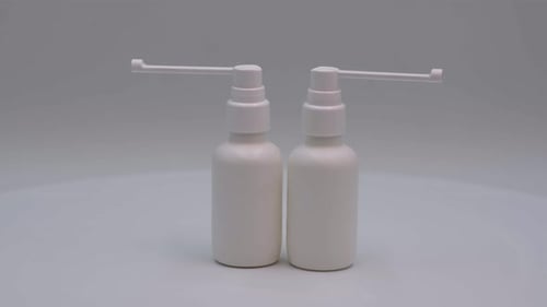 Medicine Spray Bottles Displayed on White Backdrop