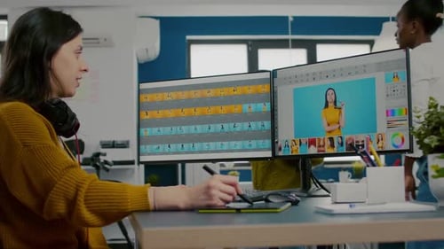 Woman Works on Photo Editing in Office