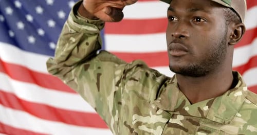 Young Adult Saluting in Front of American Flag