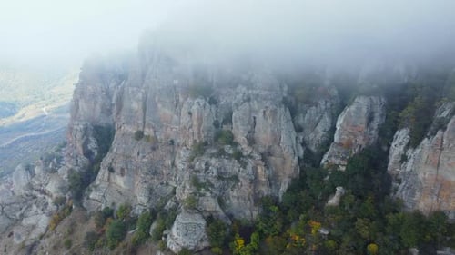 Aerial Footage Above a Foggy Mountain During Fall Season