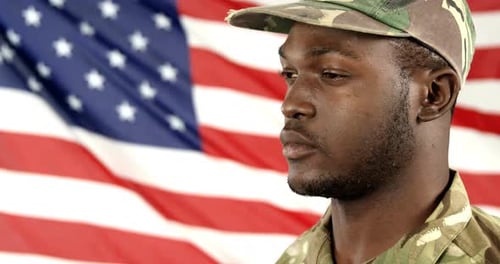 Soldier Salutes American Flag Wearing Camouflage Uniform