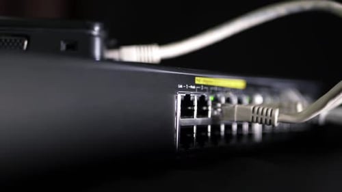 Network Switch with Ethernet Cables and Blinking Lights