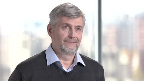 Man with Gray Hair Smiling Indoors