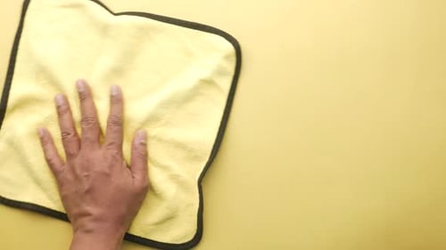 Person Hand Cleaning Table with Cloth