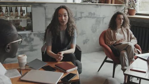 Young Business Colleagues Discussing Work in Loft Coworking Office