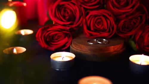 Wedding Rings and Red Roses by Candlelight