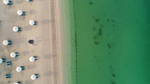 Aerial view of an empty beach with white parasol, U.A.E.