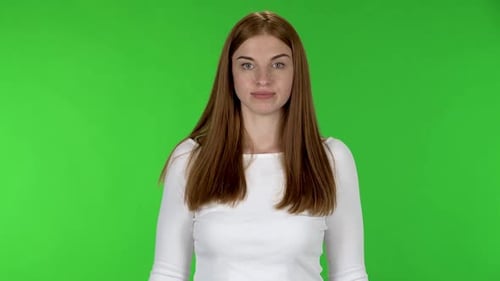 Woman Gesturing Cheerfully on Green Screen Backdrop