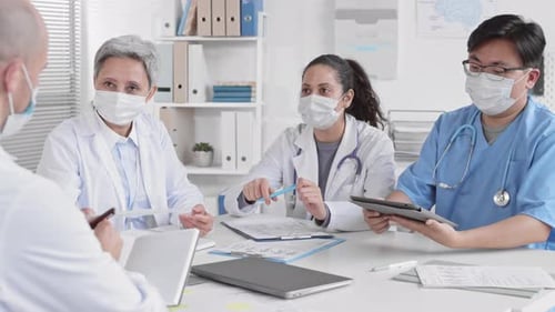 Medical Team Collaborating on Data in Office