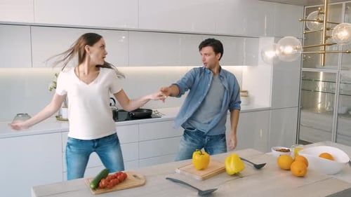 Couple Dancing Together in Modern Kitchen