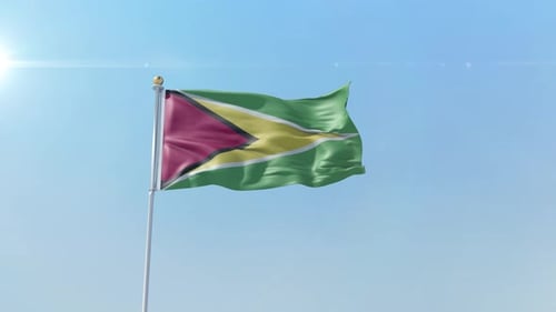 National Flag of Guyana Waving Against Clear Blue Sky