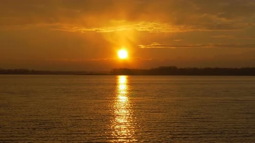 Colour Sunset Over The River With Sun And Orange Clouds