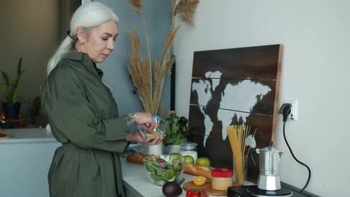 Woman Prepares Healthy Salad in Bright Kitchen