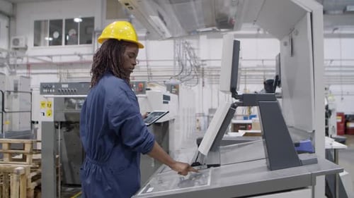 Confident Black Factory Worker Operating Industrial Machine