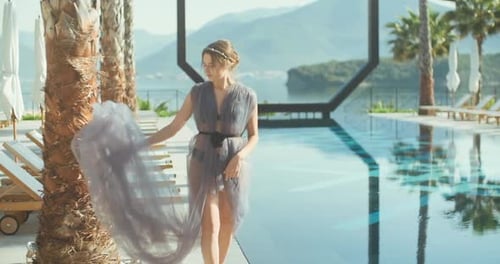 Young lady walking over the pool on holidays. Travel vacation woman relaxing