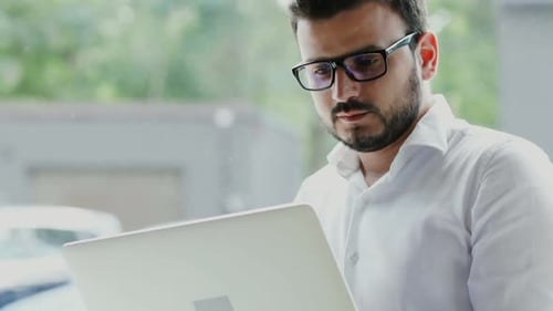 Man Working on Laptop in Bright Office