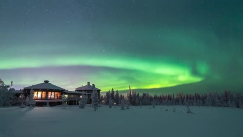 Northern lights also known as aurora borealis showing as greenement in the starry nightsky over a co