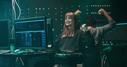 Computer Programmers Celebrate Achievement in Dark Office