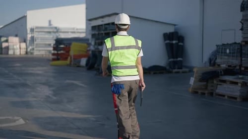 Back View of Cheerful Excited Working Man Walking and Jumping in Slow Motion Strolling at Outdoor