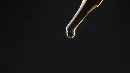 Close Up of Liquid Dropping from Pipette