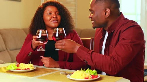 Couple Toasting With Wine During Intimate Dinner at Home