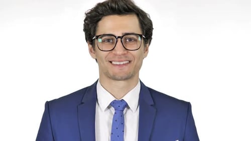 Young Adult Man Smiles and Nods in Suit