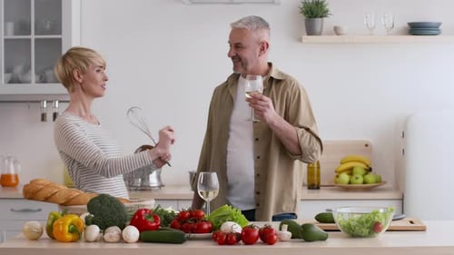 Couple Cooking Together and Dancing in Kitchen