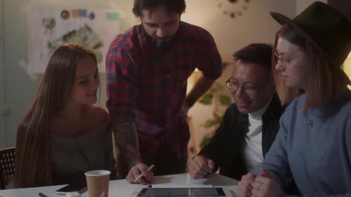 Team Collaborating with Tablet in Modern Office