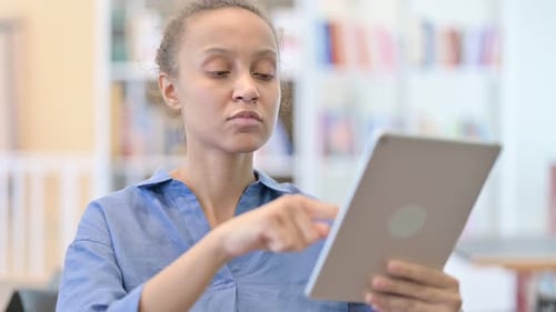 Young Adult Using Tablet Device Indoors