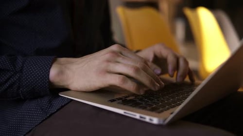 Hands Typing on Laptop Keyboard