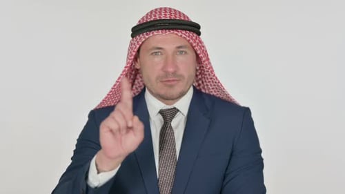Man in Traditional Dress Points No Against Background