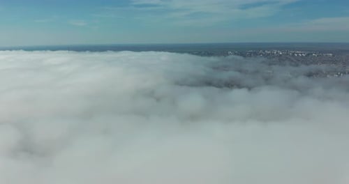 Cityscape Emerging from a Cloud Blanket