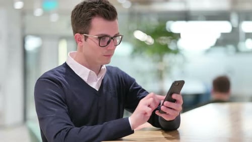 Young Businessman Using Smartphone , Text Messaging