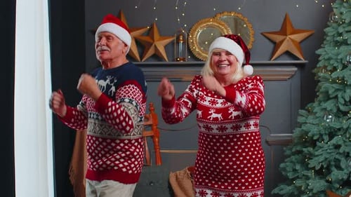Joyful Senior Couple Dancing near Christmas Tree