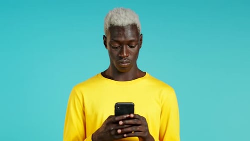 Young Adult Using Mobile Phone in Studio